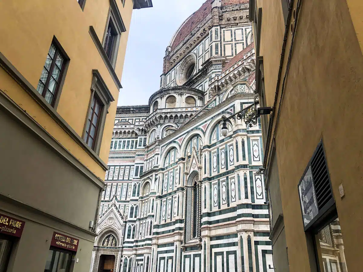 stunning shot of the duomo of florence from a side alley