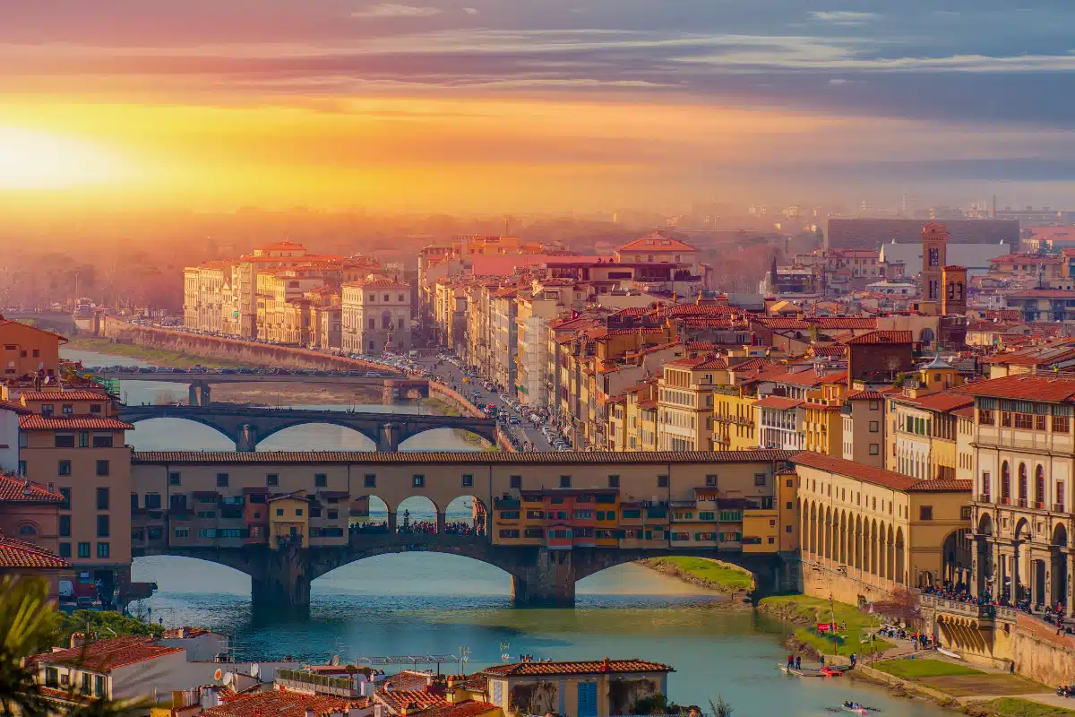 stunning drone shot at sunset of the ponte vecchio and the city center 