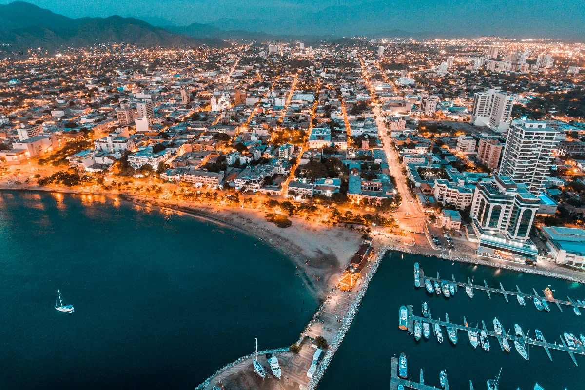 drone shot of santa marta city in the evening with the harbor and boats 