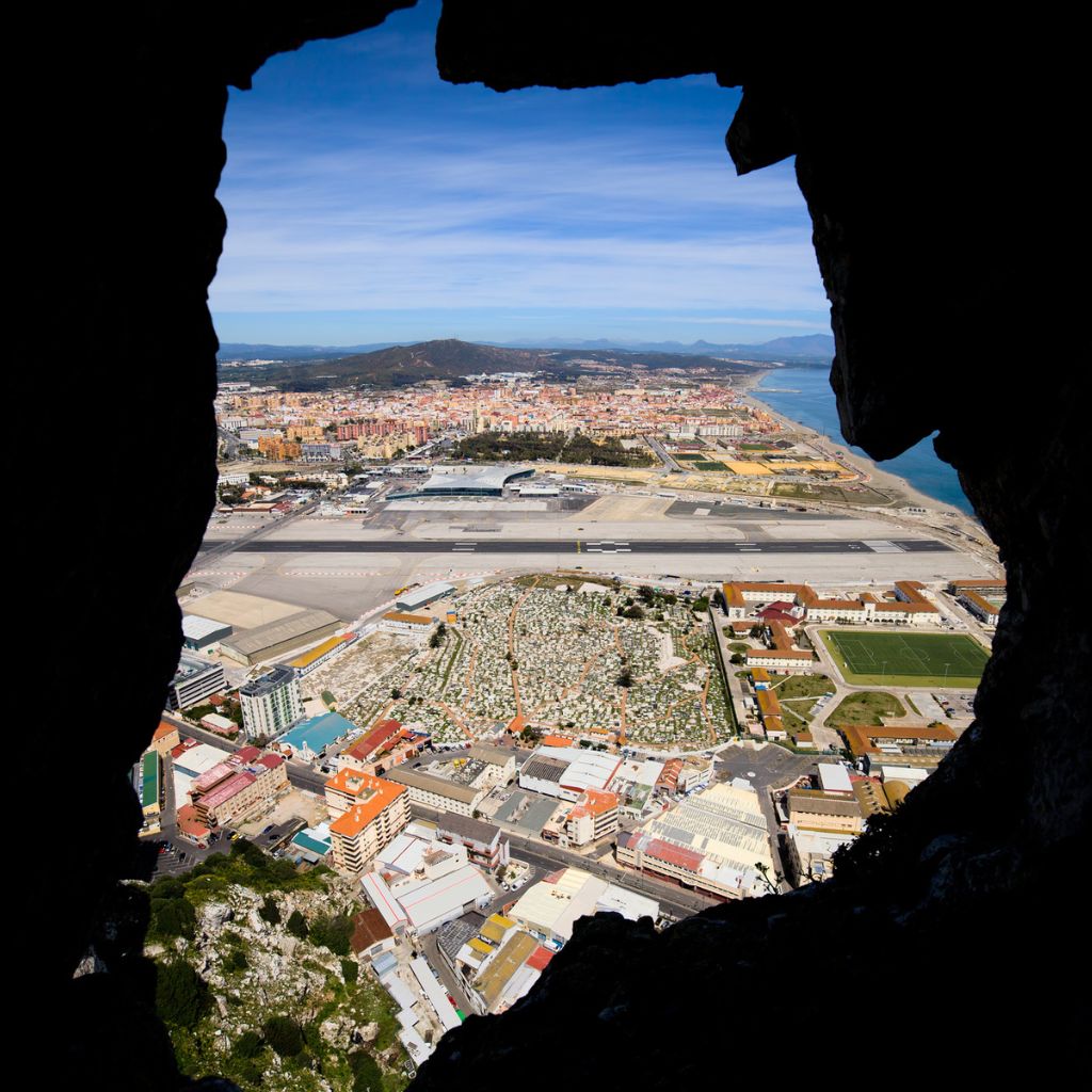 stunning view of the gibraltar airport landing strip photo taken from inside a cave