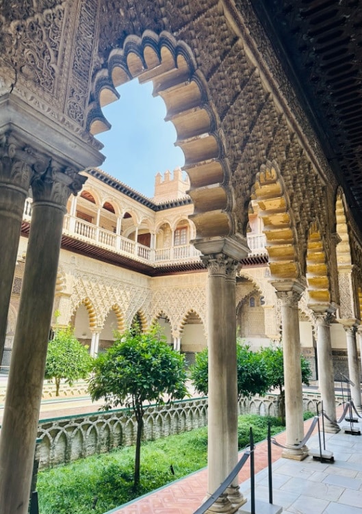 stunning real alcazar de sevilla gardens from the inside with lush green bushes