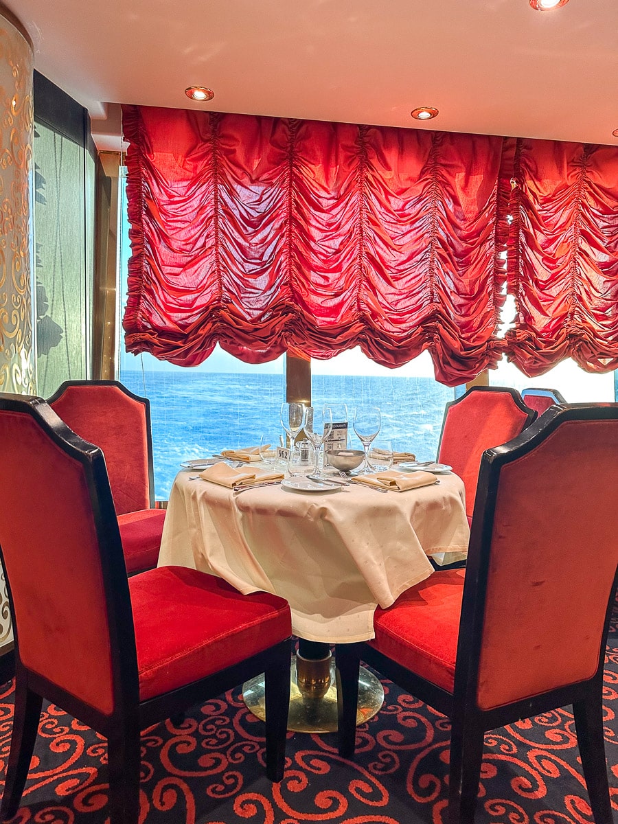 view of the ocean and a nicely set table at the msc divina villa rossa