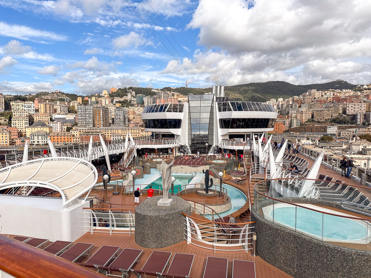 the upper deck of the msc divina with lots of pools, hot tubs and sunbeds
