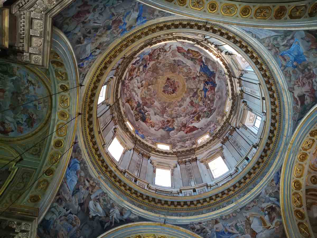 The stunning frescoes adorning the dome of a Neapolitan cathedral, a masterpiece of artistry displaying religious scenes in vibrant colors and exquisite detail.