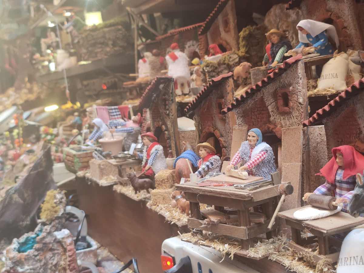 "Intricate nativity scenes line the famous San Gregorio Armeno street in Naples, with detailed figurines depicting traditional Italian life and crafts.
