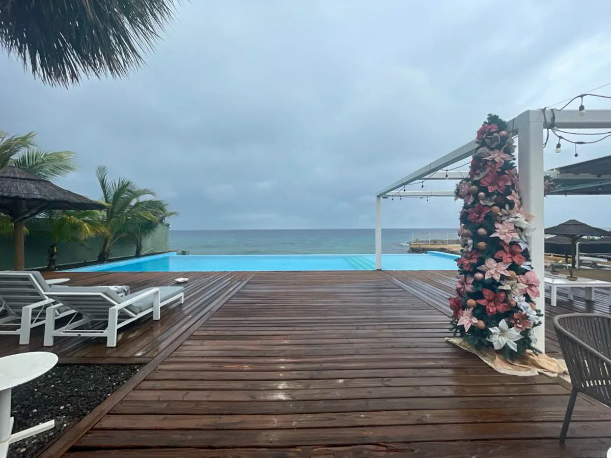 rain in Curacao over a nice pool with some seasonal decorations