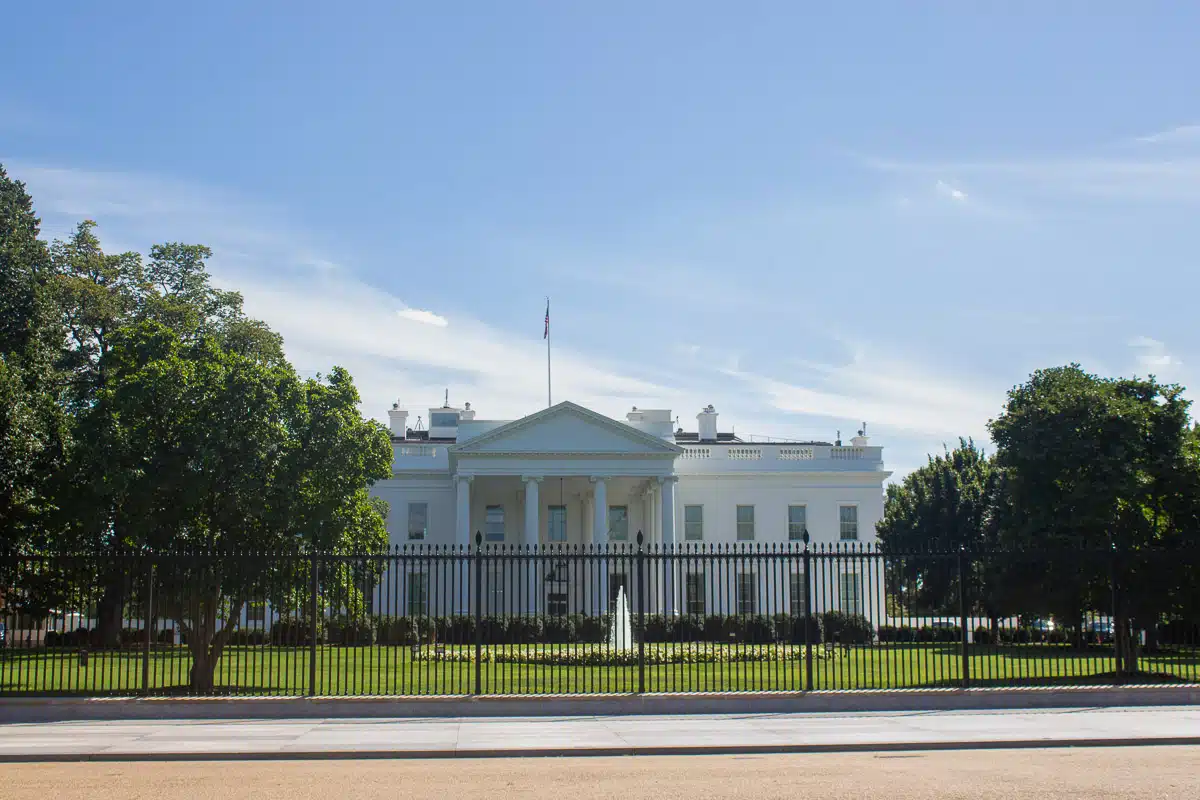 the famous white house behind a fence on a sunny day one of the most important buildings in america