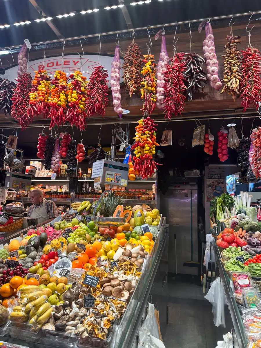 stunning markethall at the mercat de boqueria in barcelona with food stands offering lots of different colorful groceries