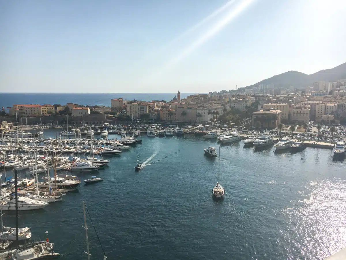 Stunning picture of Ajaccio marina and cruise port from a high vantage point with lovely houses and mediterranean sea in the background