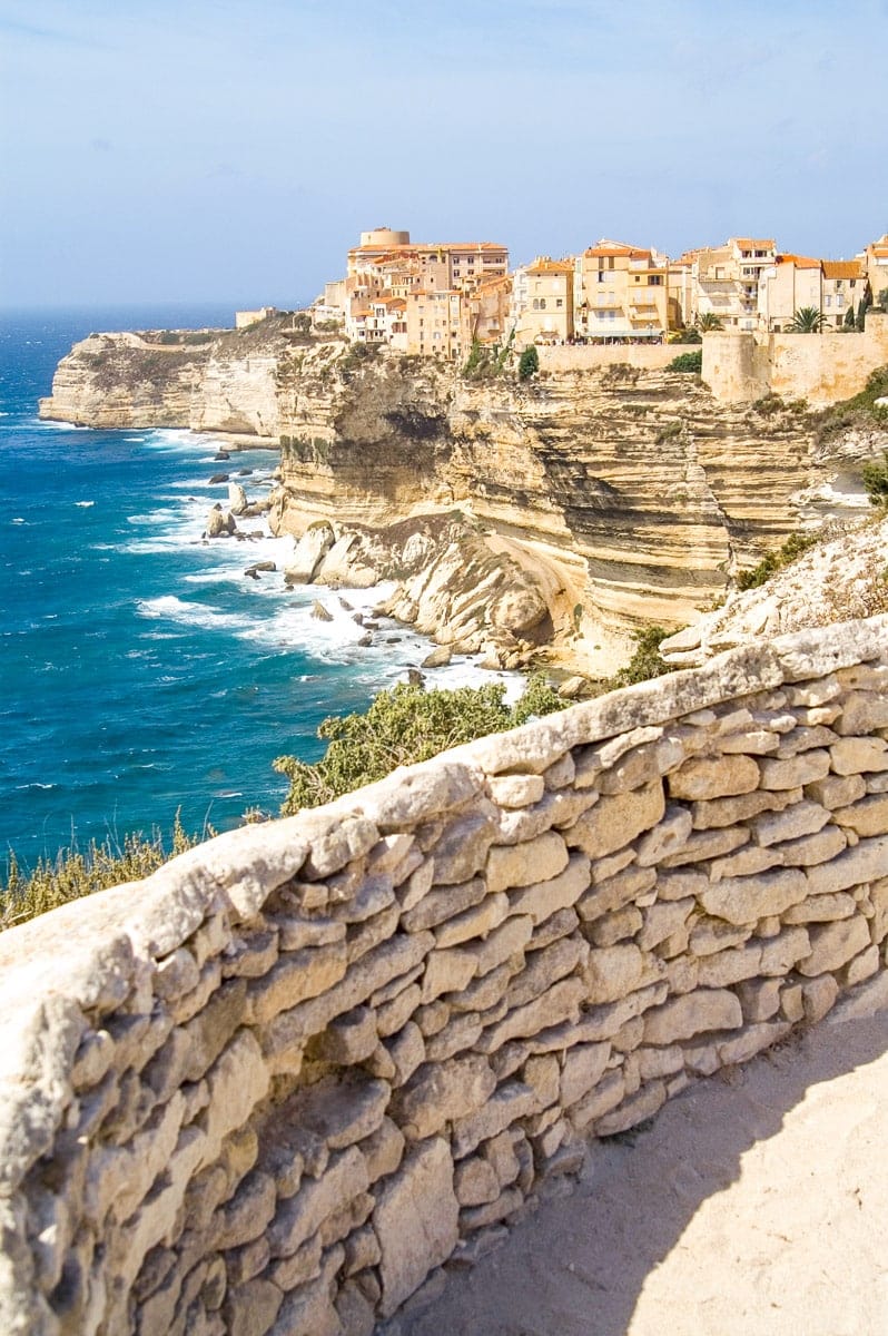 cute town in corsica called bonifacio with houses perched on a cliffside