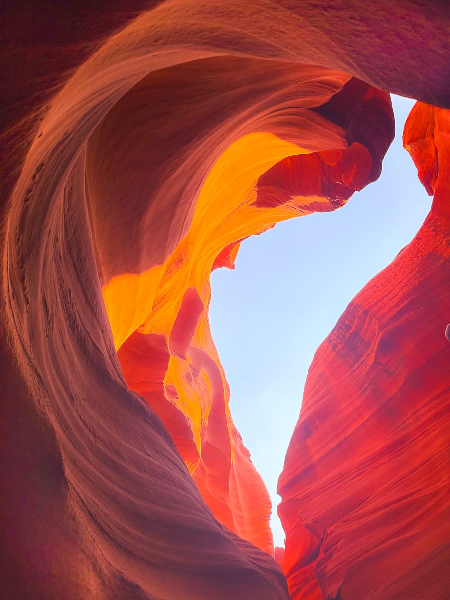 Detailed view of the vibrant red and orange sandstone walls of a slot canyon, with beautiful layered patterns in Page, Arizona."