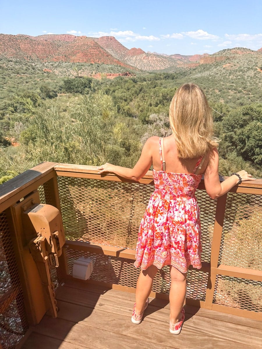 the author's wife looking through the verde canyon from an old train