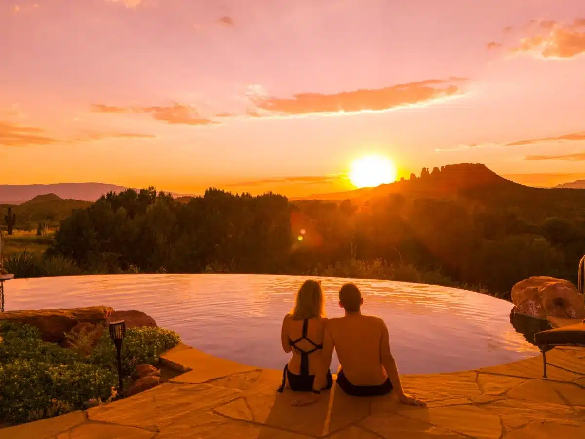 the author and his wife sitting on the edge of an infinity pool in sedona