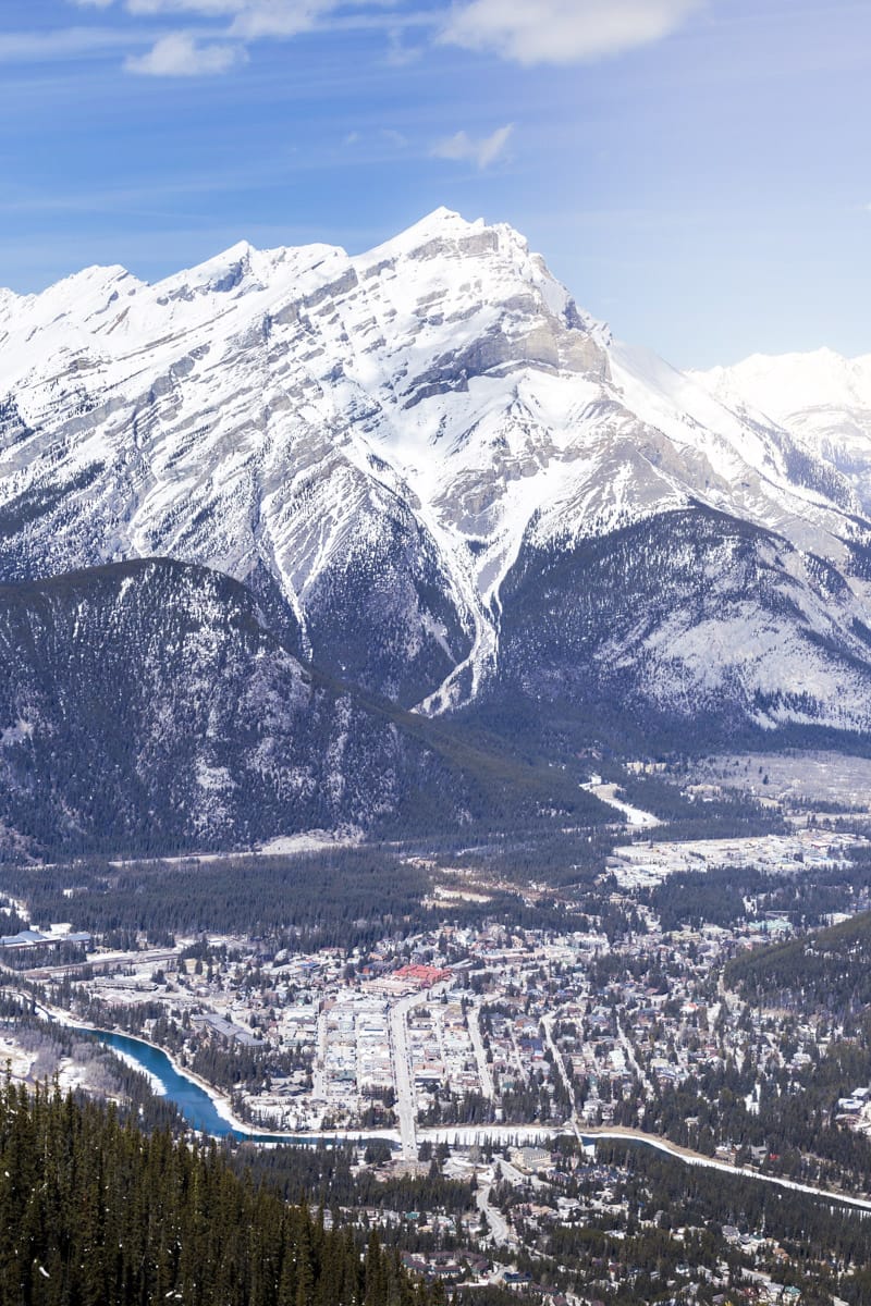 beautiful view on a winter day of a snowy mountain cap with a valley and a blue river in vail colorado