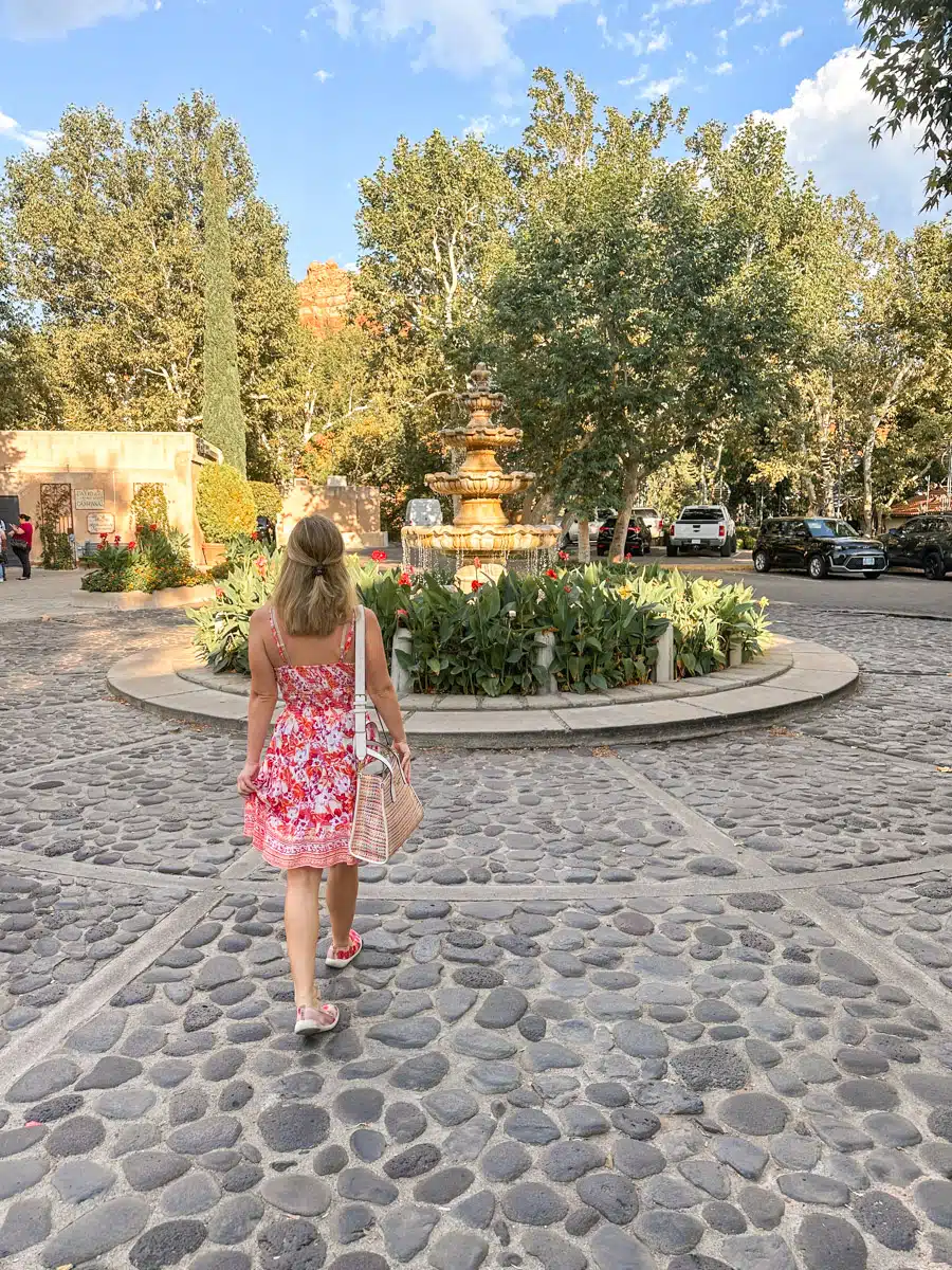 the atuhors wife in a pink dress in the scenic village in sedona