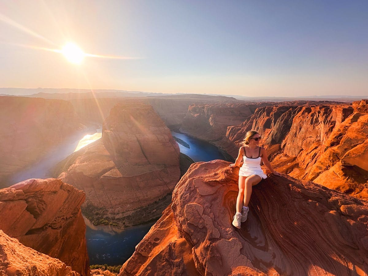 the author's wife posing on horseshoe bend in arizona