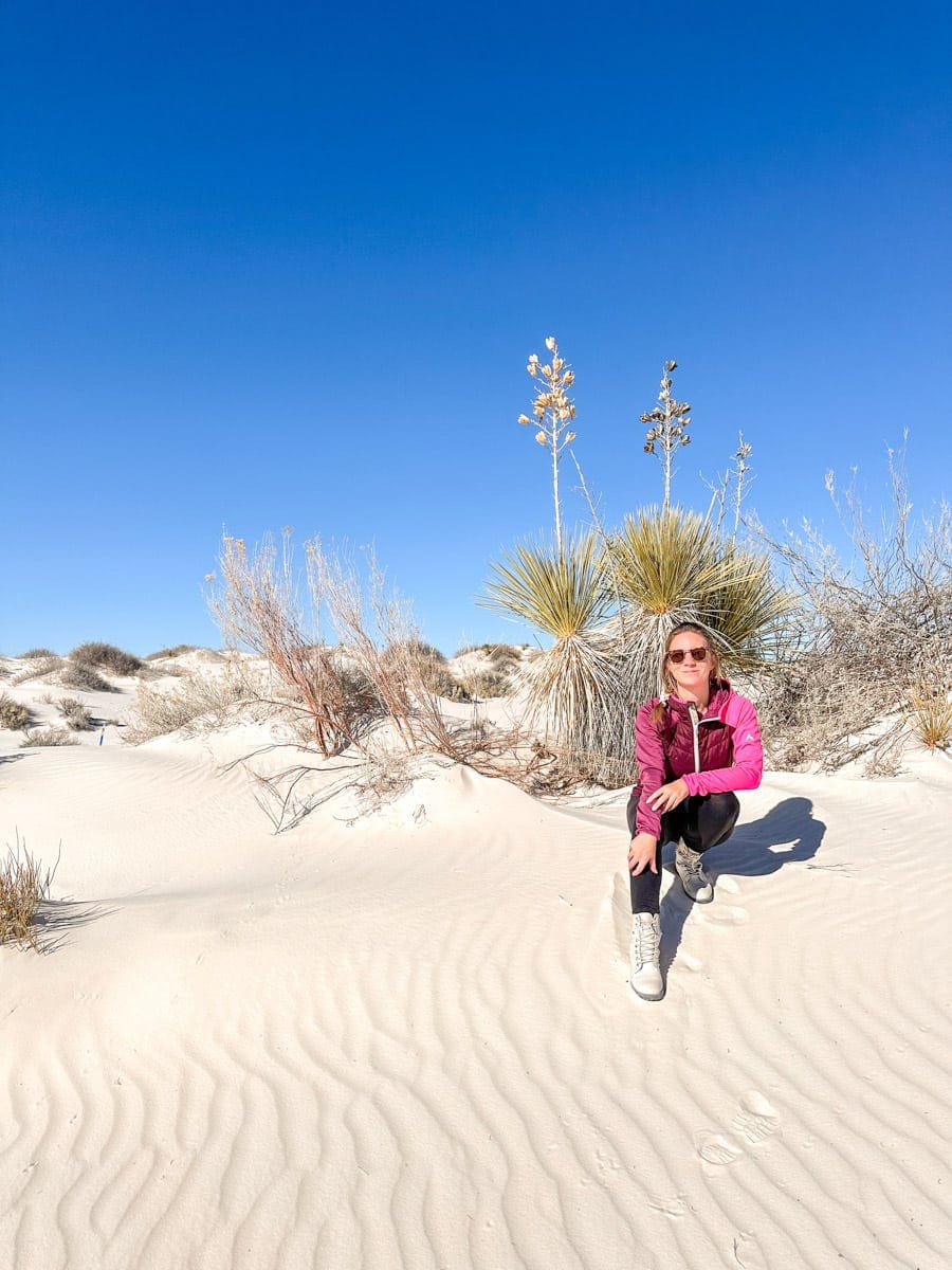 author's wife posing with a yucca plant in the white sands national park