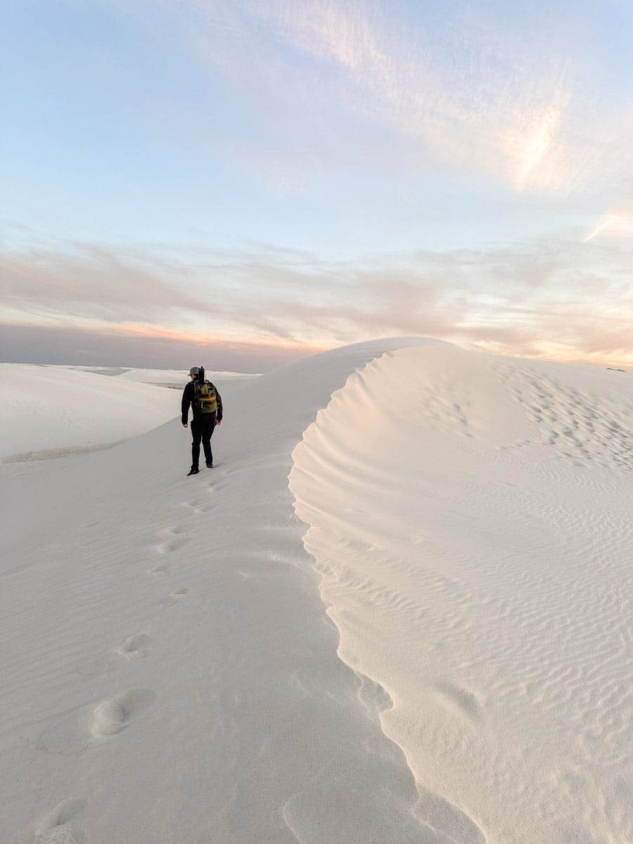the author climbing one of the beautiful white sand dunes in new mexico