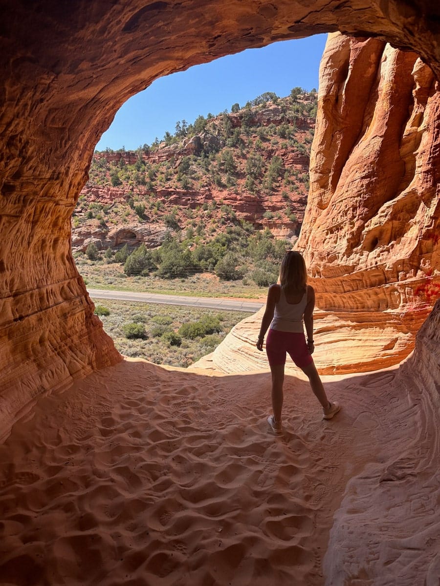 the author's wife posing inside the stunning sand caves in kanab