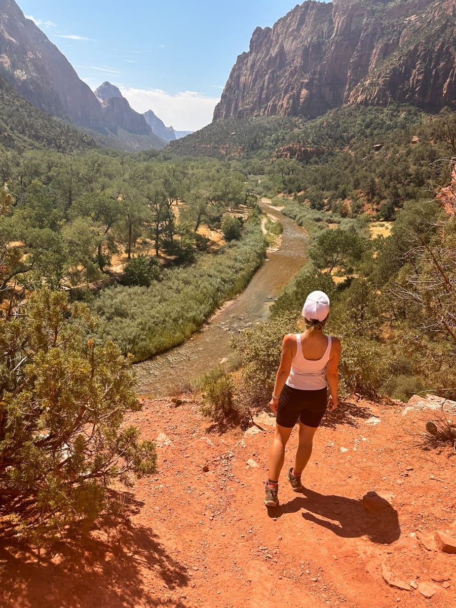 the author's wife posing in a hiker's outfit on the emerald pools trail in zion national park