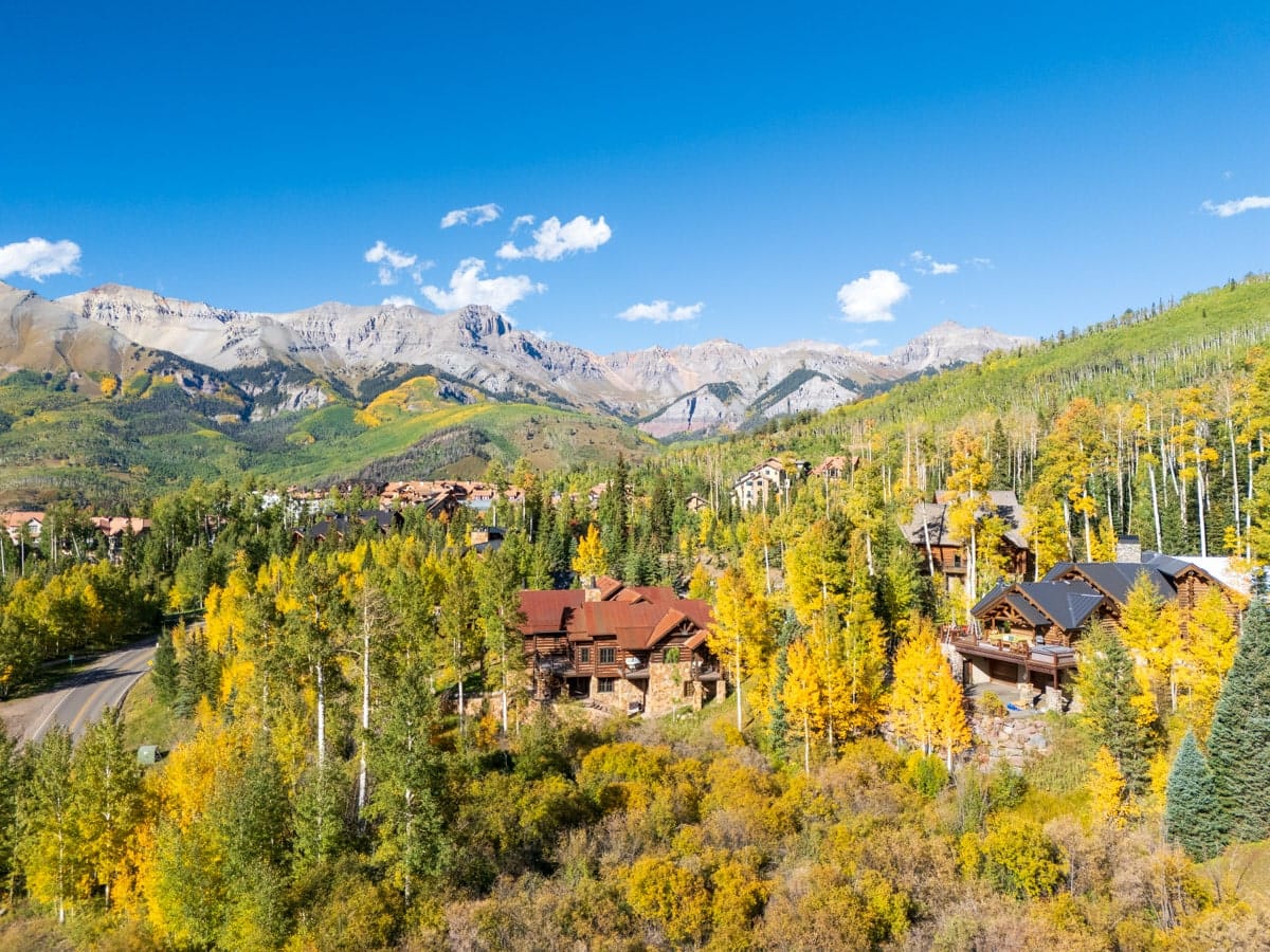 A charming mountain town nestled in the San Juan Mountains, Telluride shines with golden aspen trees, cozy alpine cabins, and dramatic peaks under a crystal-clear autumn sky. A picture-perfect fall escape in Colorado.