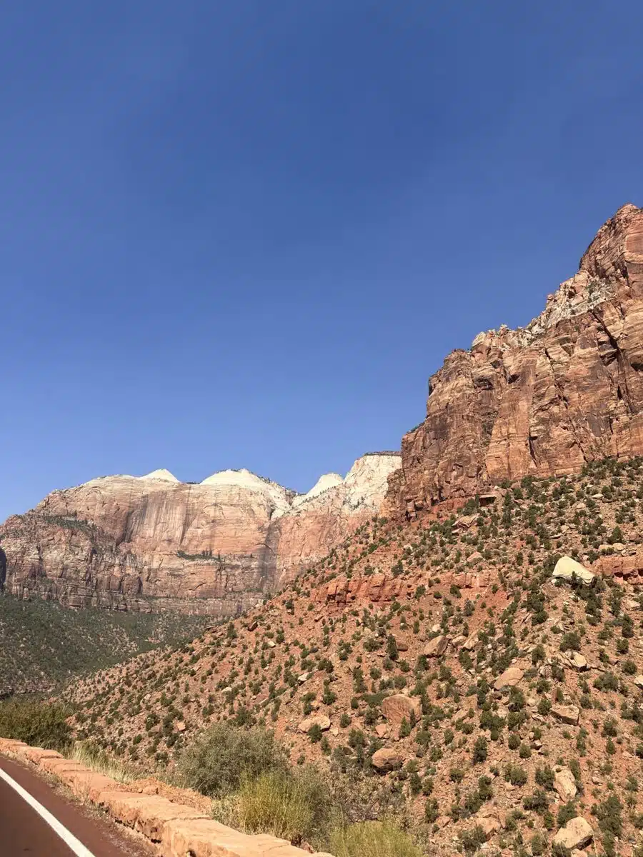 Stunning Zion National Scenic Byway with impressive red cliffs on the right side of the road that open up as you enter the park