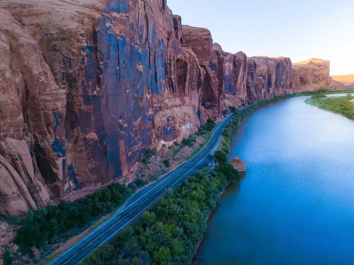stunning potash road in moab. Aerial view of the Colorado River cutting through red rock canyons near Potash Road at sunset