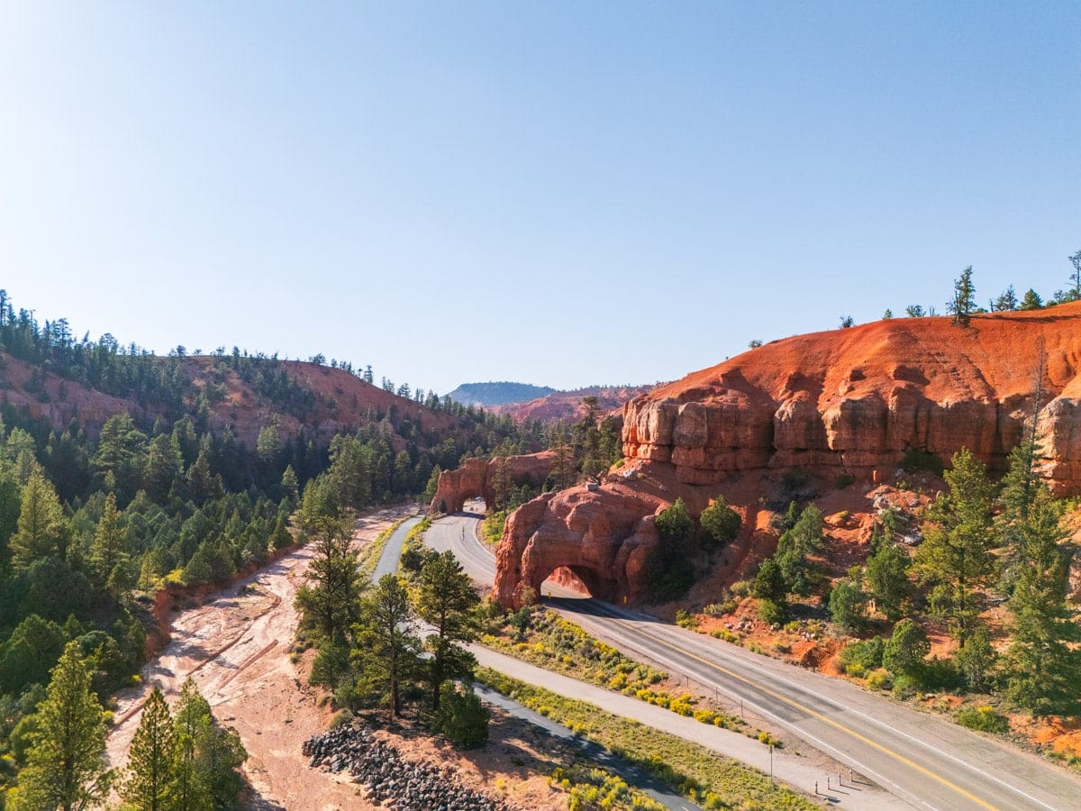 stunning drone shot of the scenic highway 12 with red rock tunnels
