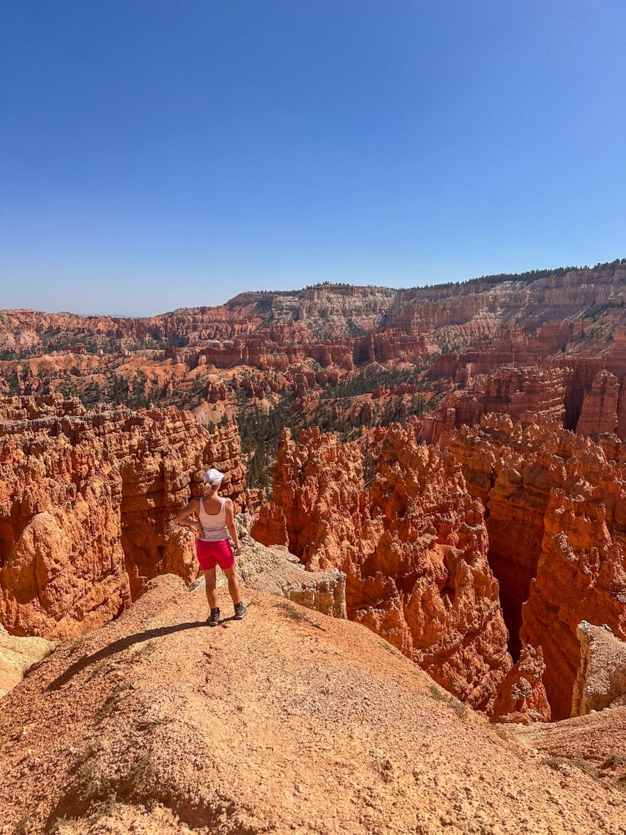 stunning view of the bryce canyon amphitheater with the author's wife in front