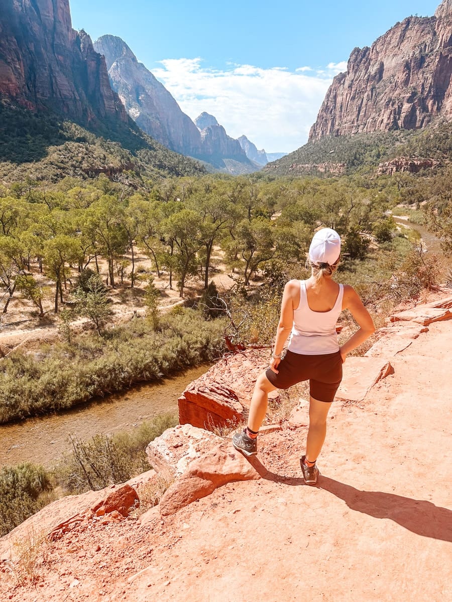 the author's wife posing on a hiking trail in zion canyon national park