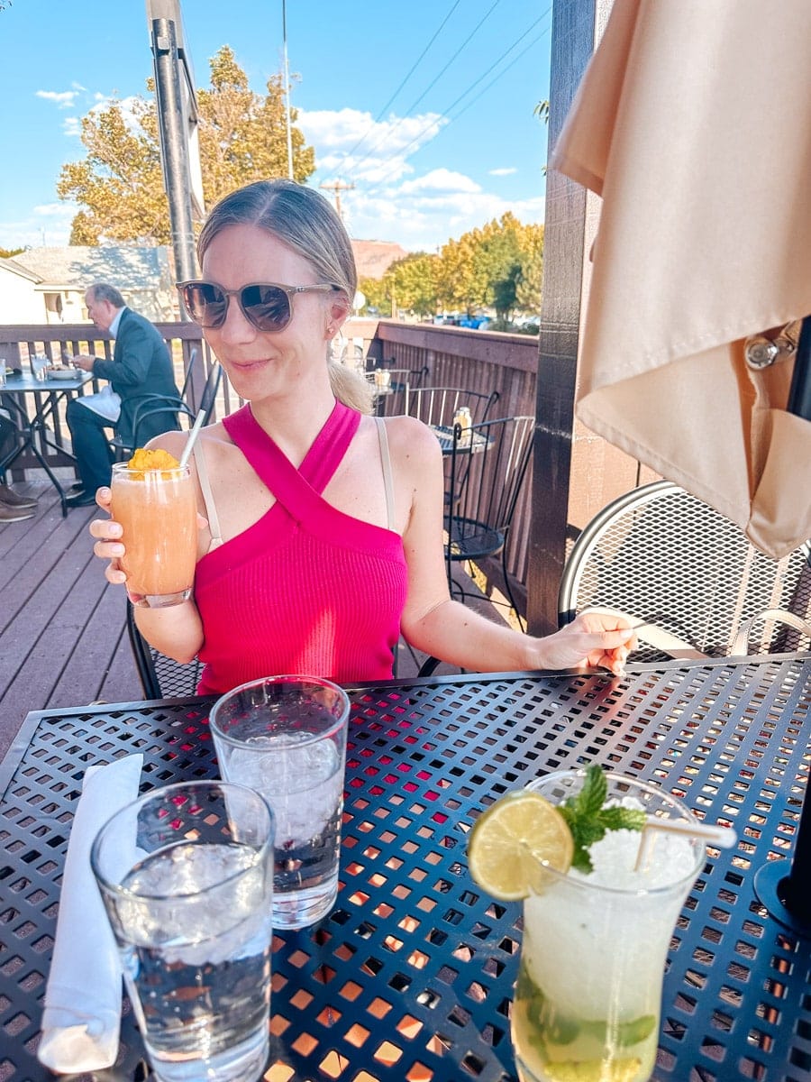 the author's wife sipping on a cocktail in kanab, utah