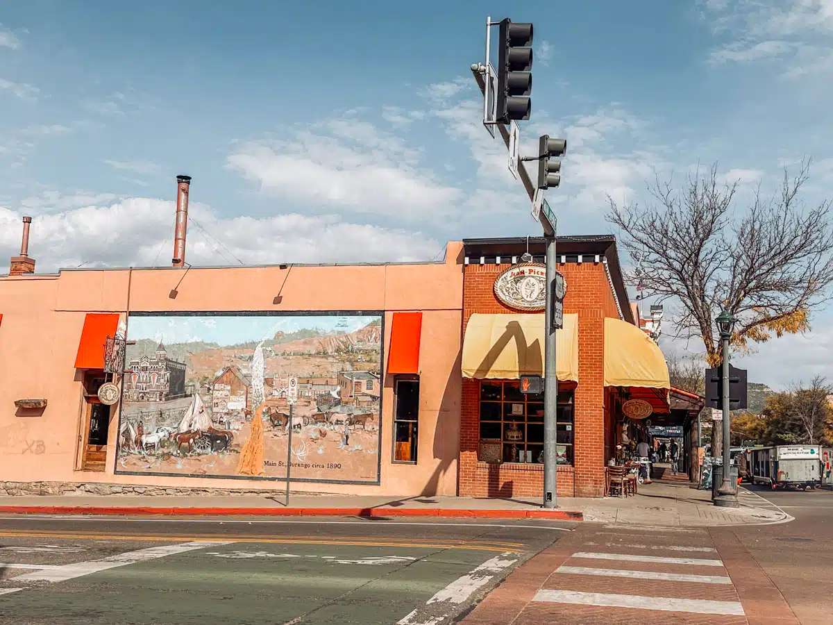 Historic downtown Durango, Colorado, with a mural depicting Main Street in the 1890s and the bright storefront of Jack's Pizza.