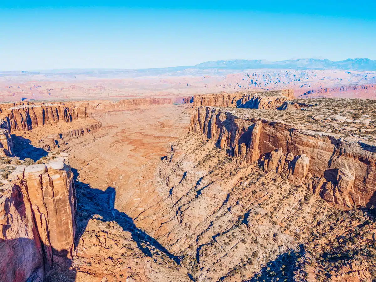 Vast panorama of rugged canyon walls and deep red rock cliffs in Canyonlands National Park
