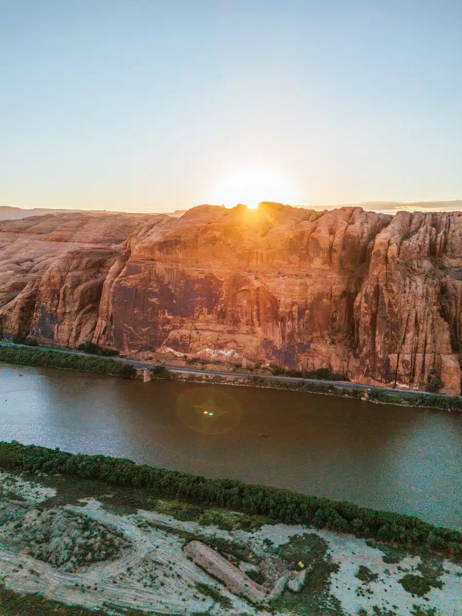 Aerial view of the Colorado River cutting through red rock canyons near Potash Road at sunset