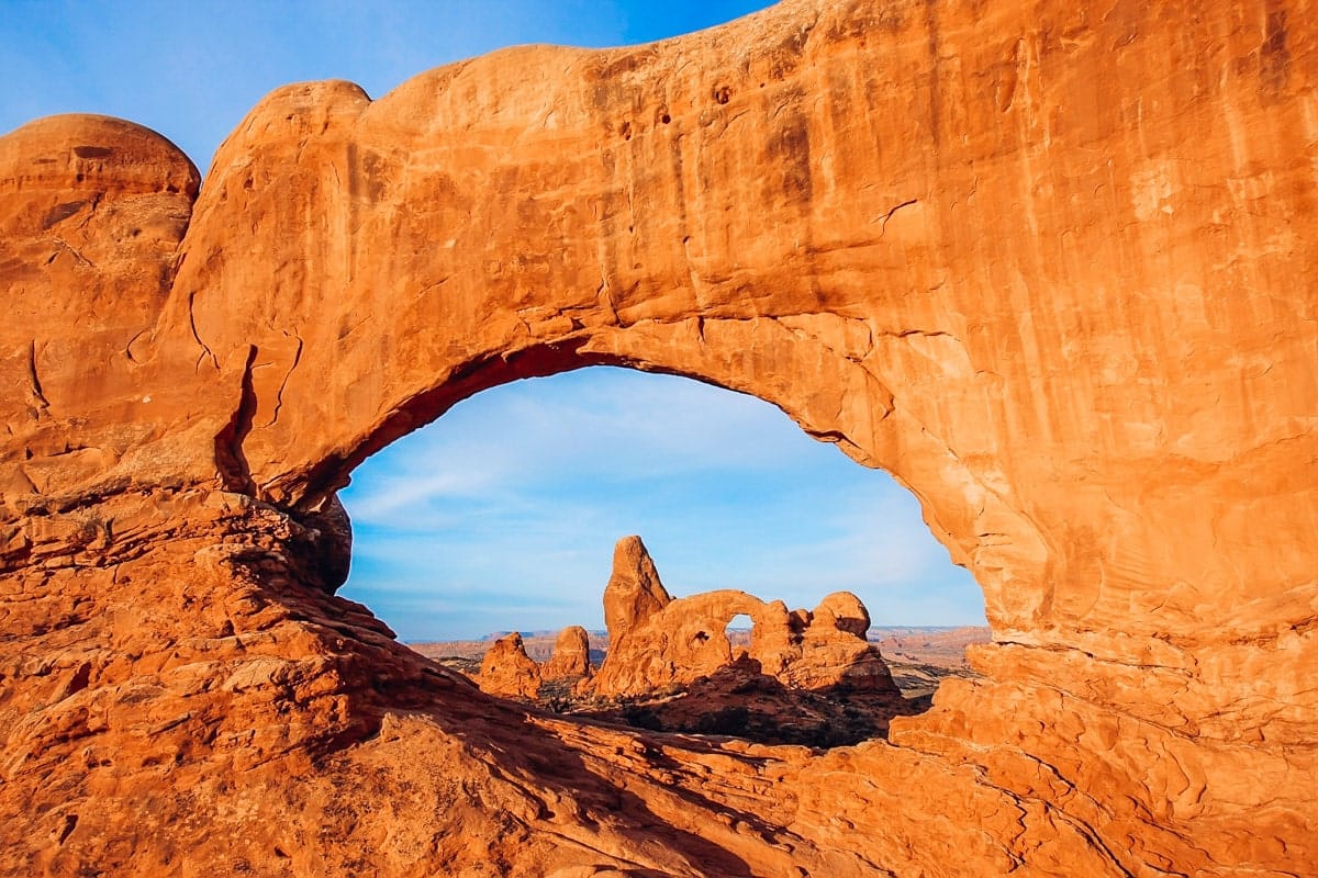 Majestic view of Turret Arch framed perfectly by the massive North Window Arch at sunrise.