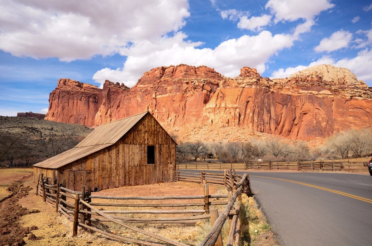 beautiful road leading near a small shed inside capitol reef national park